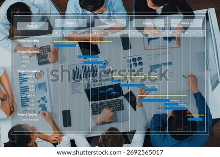 Top view analyst team utilizing BI Fintech to analyze financial data at table in meeting room. Analytic BI dashboard power on paper for business insight and strategic marketing planning. Prudent Amity
