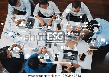 Top view analyst team utilizing BI Fintech to analyze financial data at table in meeting room. Analytic BI dashboard power on paper for business insight and strategic marketing planning. Prudent Amity