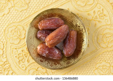 A Top View Angle Of Dates In A Golden Plate