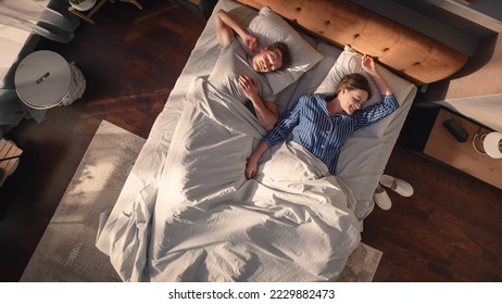 Top View Apartment: Beautiful Young Couple Sleeps in Bed, Sun Shines on Them, They Look Rested and Calm in a New Sunny Day. Joyful Waking Up of Family of Two, a Relaxation Weekend. Top Down - Powered by Shutterstock