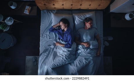 Top View Apartment: Happy Young Couple Sleeping in Bed at Night. Beautiful Girlfriend and Handsome Boyfriend Sleeping Together. Family of two Sweetly Calmly in a Double Bed. Top Down - Powered by Shutterstock