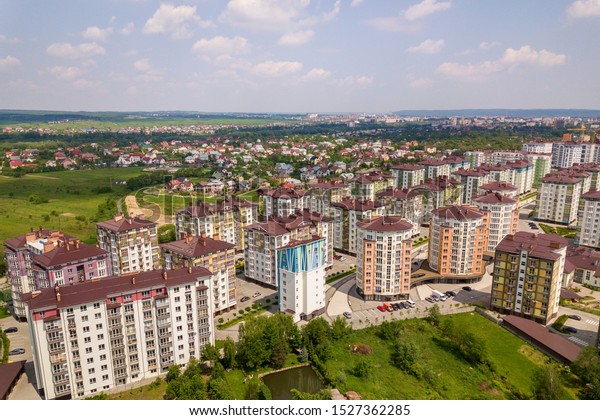 Top view of\
apartment or office tall buildings, parked cars, urban city\
landscape. Drone aerial\
photography.