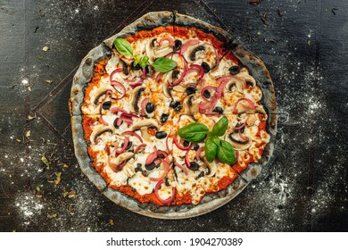 A Top View Of Appetizing Vegetarian Pizza With Black Dough And Various Vegetables