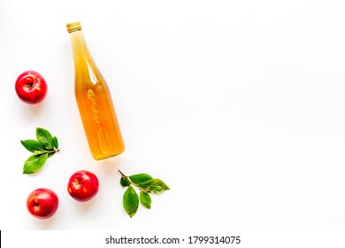 Top View Of Apple Cider Or Vinegar - Bottle With Ripe Fruits And Leaves