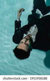 Top View Of Arabian Businessman With Closed Eyes Swimming Underwater