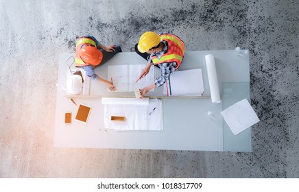 Top view of architects and engineers to help create a blueprint to build a modern building equipped with the skills to fix errors and make suggestions during construction.