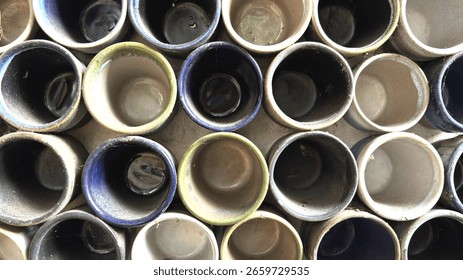 Top view of an array of colorful, empty ceramic pots