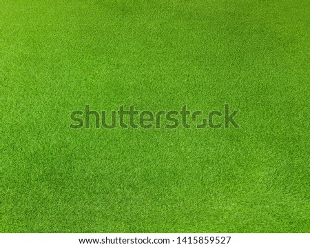 Top view artificial green grass of sports field or garden background texture pattern concept. 