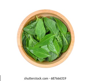top view of asia sweet basil leaves in wooden bowl isolated on white background