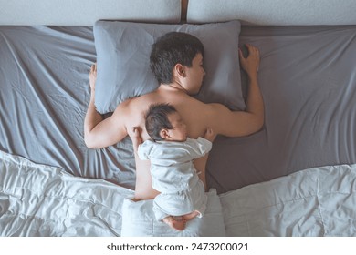 Top view of asian father sleeping on bed with little baby girl, Parenthood concepts. Love and happiness. Taking care of new life. Family, Love, Happiness Concepts. - Powered by Shutterstock