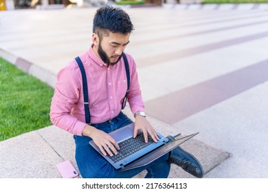 Top View Of An Asian Man Using A Laptop