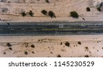 Top view of asphalt roadside crossing desert environment in USA, aerial scenery view of famous interstate landmark of Historic Route 66 located in wild lands 