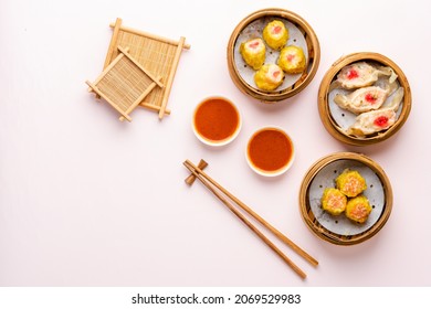 Top View Of Assorted Chinese Dimsum In Bamboo Basket. Dimsum Is A Large Range Of Small Dishes That Cantonese People Traditionally Enjoy In Restaurants For Breakfast And Lunch.