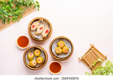 Top View of Assorted Chinese Dimsum in bamboo basket. Dimsum is a large range of small dishes that Cantonese people traditionally enjoy in restaurants for breakfast and lunch. - Powered by Shutterstock