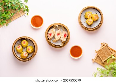 Top View Of Assorted Chinese Dimsum In Bamboo Basket. Dimsum Is A Large Range Of Small Dishes That Cantonese People Traditionally Enjoy In Restaurants For Breakfast And Lunch.