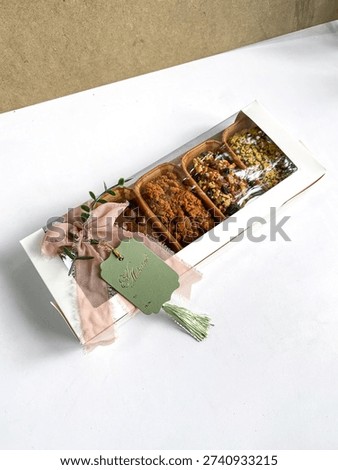 Top view of assorted homemade mini loaf cakes placed in paper baking molds and cooling on a metal wire rack over a white background.