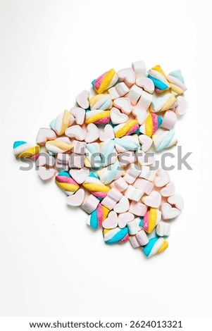 Top view of assorted marshmallows in soft colors like pink, blue, yellow, and white. A fun and romantic candy concept, perfect for Valentine's Day or dessert themes.