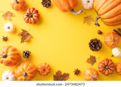 Top view of assorted pumpkins and fall leaves arranged in a circle on a yellow background. Perfect for autumn and Thanksgiving themes - Powered by Shutterstock