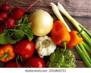 Top view. Assorted vegetables from above. Radishes, onions, peppers, garlic, tomatoes, artichoke. Fresh produce. Harvest. Agriculture. Nutrition. Diet. Healthy eating. Vegetarian. Vegan. Organic. - Powered by Shutterstock