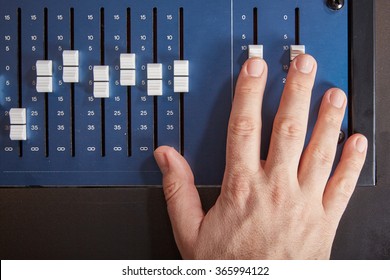 Top View Of An Audio Mixer With A Male Hand On It