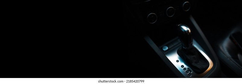 Top view of automatic gearbox selector on black background with copy space. Panoramic banner view. Advertising design concept.