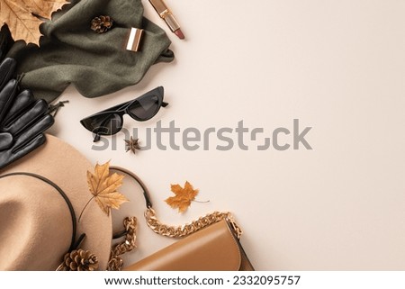 Top view of autumn ensemble. Featuring brimmed hat, gloves, stylish glasses, elegant scarf, purse, lipstick, leafage, anise, pine cones artfully arranged on white surface with space for text or ad
