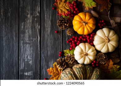 Top View Of  Autumn Maple Leaves With Pumpkin And Red Berries On Old Wooden Background. Thanksgiving Day Concept.