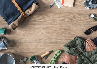 Top View of Autumn/Winter Travel Stuff with Copy Space on Wood Background 