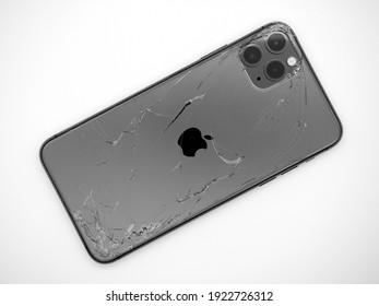 Top view the back of space grey smartphone iPhone 11 Pro max with a broken glass close-up isolated on white background