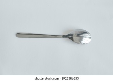 Top view of the back of a used stainless steel generic big spoon. It is cutlery, tableware, kitchen supplies for all occasion. It has durable quality and timeless design.