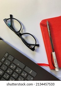 Top View Background Of Workplace With Notebook, Pen , Glasses And Lap Top On  White  Background . Business Concept Mockup