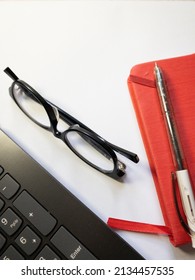 Top View Background Of Workplace With Notebook, Pen , Glasses And Lap Top On  White  Background . Business Concept Mockup