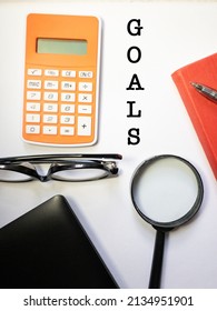 Top View Background Of Workplace With Notebook,   Glasses , Lap Top, Calculator And Magnifying Glass  On  White  Background . Business Concept Mockup