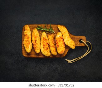 Top View Of Baked Chicken Fingers Nuggets On Dark Background