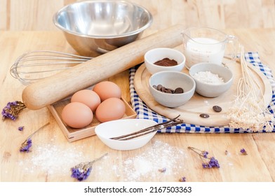 Top View Baking Preparation on wooden Table,Baking ingredients. Bowl, eggs and flour, rolling pin and eggshells on wooden board,Baking concept - Shutterstock ID 2167503363