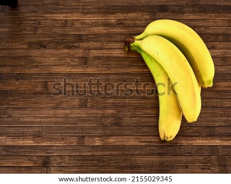 top view of bananas on a wooden table, horizontal view