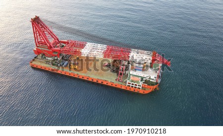 Top view of a barge equipped with a powerful crane currently in rest position for a transit. Oil and Gas, Construction, heavy lift background.