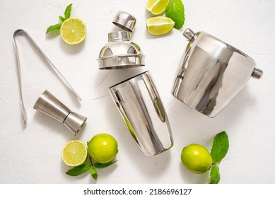 Top View Of Bartenders Coctail Tools Set. Steel Shaker, Measure, Pliers With Lime
