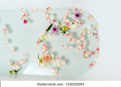 Top View Of Bath Filled With Bubble Water, Flowers And Petals, Spa Or Selfcare Concept