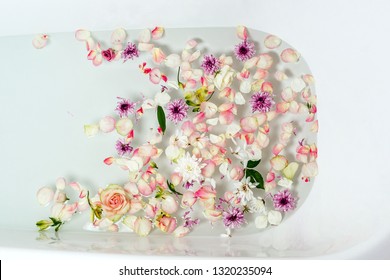 Top View Of Bath Filled With Bubble Water, Flowers And Petals, Spa Or Selfcare Concept