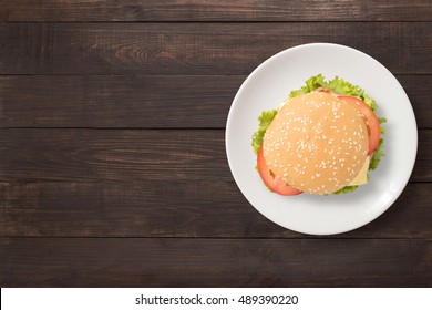 Top View BBQ Burger On White Dish On Wooden Background. Copy Space For Your Text.