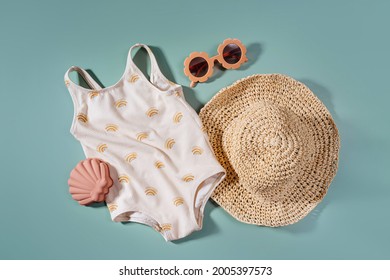 Top View Of Beach Summer Accessories For Kids. Fashion Swimsuit And Hat For Children.  Flat Lay