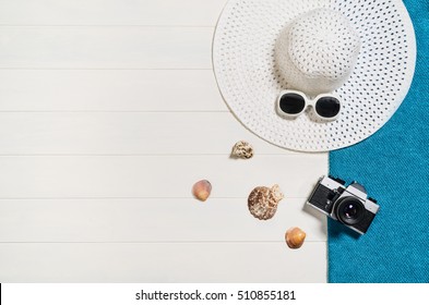 Top View Of Beach Summer Accessories With Copy Space. Lay Flat Holiday Fashion Background On White Wooden Table Or Floor. Horizontal Frame For Spa Or Wellness Concept.