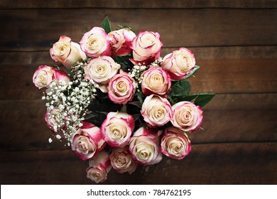 Top View Of A Beautiful Bouquet Of A Dozen Red And White Roses With Baby's Breath Shot From Above. Selective Focus On Top Of Roses With Extreme Shallow Depth Of Field.