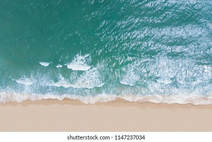 Top View Of Beautiful Sand Beach With Turquoise Sea Water,Wave Propagation,aerial View From Drone Camera / Summer Concept.