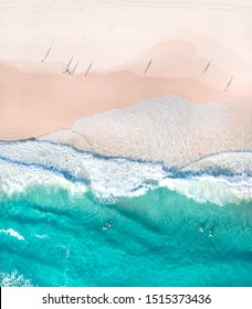 Top view of beautiful white sand beach with turquoise sea water and palm trees, aerial drone shot
