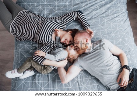 Similar – Image, Stock Photo Man reading with wife and son sleeping