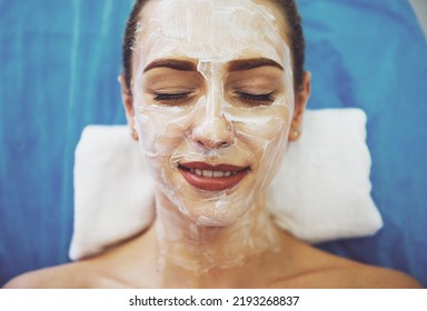Top view of beautiful young woman getting face skin treatment, lying with cream on her face - Shutterstock ID 2193268837