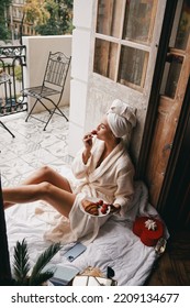 Top View Of Beautiful Young Woman In Bathrobe Enjoying Brunch While Relaxing On The Hotel Balcony