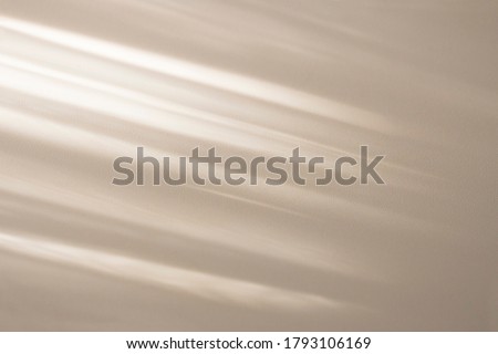 Top view of beige light bokeh shadow on sand color background. Flat lay with shadow on the wall. Minimal summer concept. Creative copyspace for overlay on product presentation, backdrop and mockup.